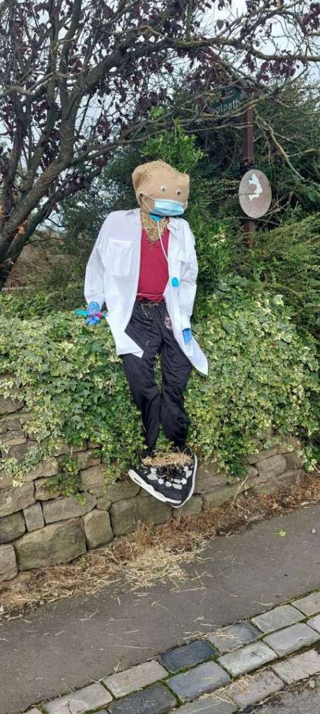 A screcrow dressed as a NHS Hero