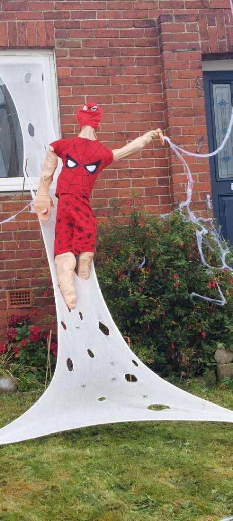 A screcrow dressed as Spiderman