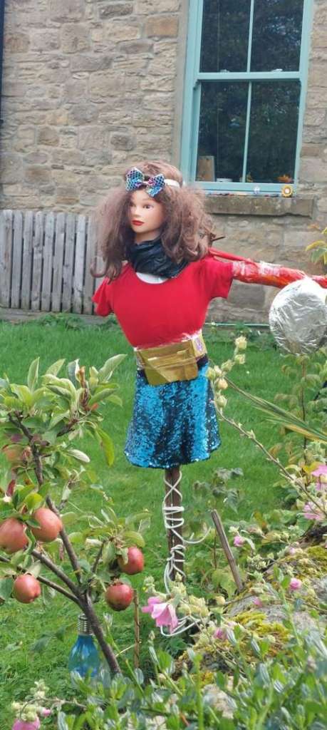 A screcrow dressed as Superwoman