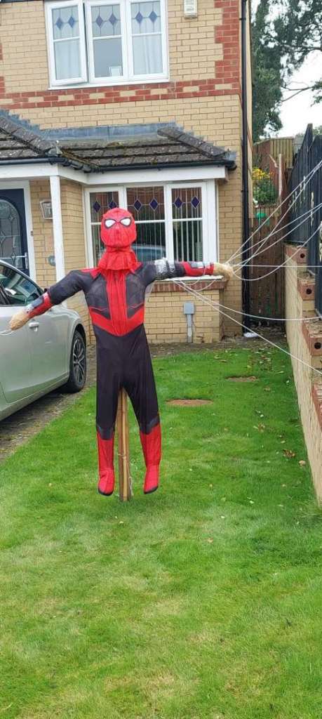 A screcrow dressed as Spideman