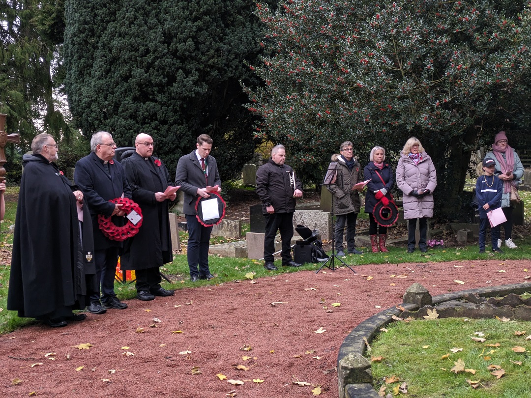 Attendees at the memorial taking part in the Remembrance Service